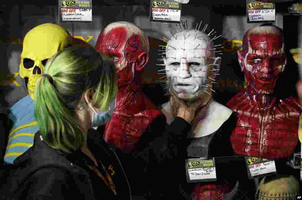 Jenn Brown of CFX (Composite Effects) fixes a silicon mask from the movie franchise &quot;Hellraiser&quot; during Preview Night at the 2022 Comic-Con International at the San Diego Convention Center, in San Diego, California, July 20, 2022.