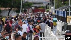 FILE - Pedestrians use the Simon Bolivar International Bridge to cross between San Antonio, Venezuela and Cucuta, Colombia, Aug. 5, 2022. It is open to pedestrians only. 