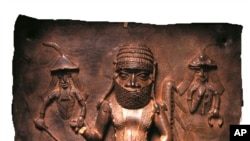 This photo from the Horniman Museum and Gardens shows a Benin copper alloy plaque featuring Benin Chief Uwangue and Portuguese traders. The museum announced Sunday it would return a collection of Benin Bronzes looted in the late 19th century from what is now Nigeria. 