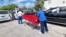 The body of a migrant from a vessel that capsized off the coast of The Bahamas is taken away by mortuary workers, in Nassau, Bahamas, July 24, 2022.