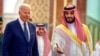 In this photo released by the Saudi Royal Palace, Saudi Crown Prince Mohammed bin Salman, right, welcomes President Joe Biden upon his arrival at Al-Salam palace in Jeddah, Saudi Arabia, July 15, 2022.