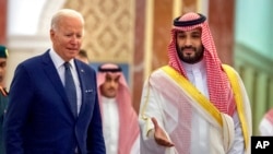 In this photo released by the Saudi Royal Palace, Saudi Crown Prince Mohammed bin Salman, right, welcomes President Joe Biden upon his arrival at Al-Salam palace in Jeddah, Saudi Arabia, July 15, 2022.