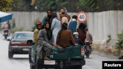 Taliban fighters drive a car on a street following the killing of al-Qaida leader Ayman al-Zawahiri in a U.S. strike over the weekend, in Kabul, Afghanistan, Aug. 2, 2022.
