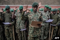 National Youth Service (NYS) personnel take an oath as they gather before escorting the electoral material at the county hall in Eldort on Aug. 8, 2022, ahead of Kenya's general election.