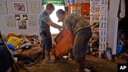 Volunteers from the local Mennonite community clean flood-damaged property from a house at Ogden Hollar in Hindman, Ky., July 30, 2022.