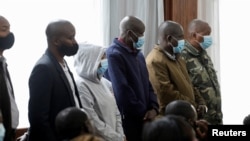 Those accused in the 2016 killing of human rights lawyer Willie Kimani and two others stand at the dock before the pronouncement of a verdict, at the Milimani Law Courts in Nairobi, Kenya, July 22, 2022. 