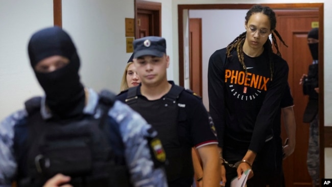 WNBA star and two-time Olympic gold medalist Brittney Griner is escorted to a courtroom for a hearing, in Khimki, outside Moscow, Russia, July 27, 2022. Evgenia Novozhenina/Pool Photo via AP)