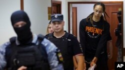WNBA star and two-time Olympic gold medalist Brittney Griner is escorted to a courtroom for a hearing, in Khimki, outside Moscow, Russia, July 27, 2022.
