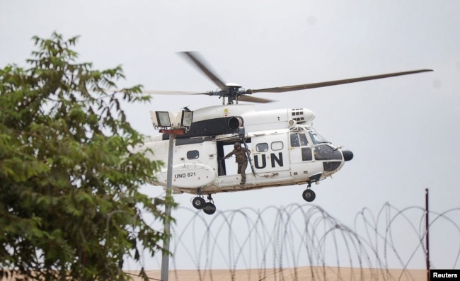 A United Nations Organization Stabilization Mission in the Democratic Republic of the Congo (MONUSCO) peacekeeper rides on a helicopter above the compound of U.N. peacekeeping force's warehouse in Goma in the North Kivu province of the Democratic Republic of Congo, July 26, 2022.