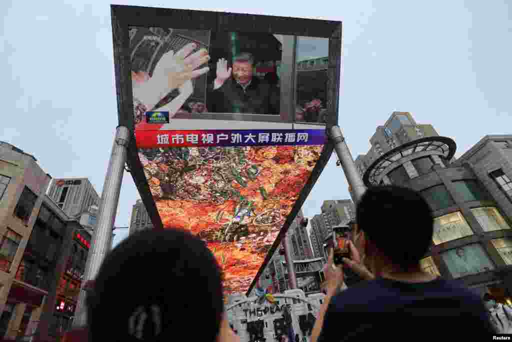 A giant screen shows news footage of Chinese President Xi Jinping visiting Xinjiang Uyghur Autonomous Region, at a shopping center, in Beijing, China.