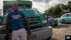 FILE: Drivers wait their turn to fuel their vehicles at a gas station in Havana, Cuba, July 14, 2022.