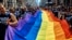 FILE - Reveler carry a LTBGQ flag along Fifth Avenue during the New York City Pride Parade on June 24, 2018.