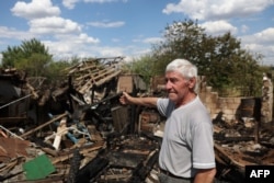 A local resident, 79, reacts next to his house destroyed by alleged Russian shelling in Bakhmut, Donetsk region, July 13, 2022, amid the Russian invasion of Ukraine.
