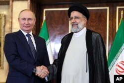 Presiden Rusia Vladimir Putin, kiri, dan Presiden Iran Ebrahim Raisi berpose sebelum pembicaraan mereka di istana Saadabad di Teheran pada 19 Juli 2022. (Sergei Savostyanov, Sputnik/via AP)