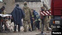 Rescuers extract a survivor from a residential building damaged by a Russian military strike in the town of Chasiv Yar, in Donetsk region, Ukraine, July 11, 2022.