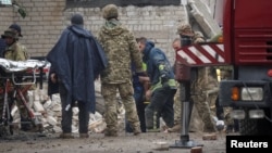 Rescuers extract a survivor from a residential building damaged by a Russian military strike in the town of Chasiv Yar, in Donetsk region, Ukraine, July 11, 2022.