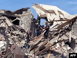 FILE - Rescuers removing debris after a military strike on Bakhmut, Donetsk region, amid Russia's military invasion launched on Ukraine, in this picture released by Ukrainian Emergency Service on Aug. 2, 2022.