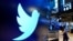 FILE: The logo for Twitter appears above a trading post on the floor of the New York Stock Exchange, Nov. 29, 2021.