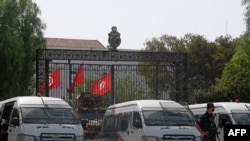 Tunisian police stand guard outside the parliament in Tunis on July 27, 2021.