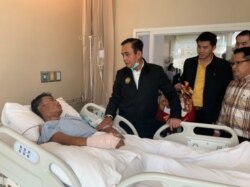 Thailand's Prime Minister Prayuth Chan-ocha visits an injured man in a hospital following a shooting rampage involving a Thai soldier, in Nakhon Ratchasima, Thailand, Feb. 9, 2020.