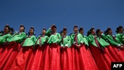 Jeunes femmes en robe hanbok assistant à une cérémonie traditionnelle pour marquer l’âge adulte au village Namsan Hanok à Séoul. La cérémonie marque l’âge de 19 ans, lorsqu'une personne est légalement en mesure de faire des choix de vie et de voter. (Ed Jones/AFP/20 mai 2019)