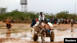 Newly arrived Somali refugees ride a donkey at the Ifo Extension refugee camp in Dadaab, near the Kenya-Somalia border, October 19, 2011.