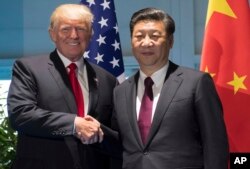 President Donald Trump and Chinese President Xi Jinping shake hands as they arrive for a meeting on the sidelines of the G-20 Summit in Hamburg, Germany, July 8, 2017.