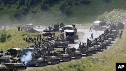 A column of Russian armored vehicles on its way to the South Ossetian capital Tskhinvali in the Georgian breakaway region, South Ossetia, August 9, 2008 file photo