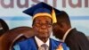 Zimbabwe's President Robert Mugabe, center-right, arrives to preside over a student graduation ceremony at Zimbabwe Open University on the outskirts of Harare, Zimbabwe Friday, Nov. 17, 2017. Mugabe is making his first public appearance since the military put him under house arrest earlier this week. (AP Photo/Ben Curtis)