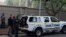 FILE: Members of the South African Asset Forfeiture Unit and other law enforcement agencies arrive to search the Gupta family compound in Johannesburg on 4.16.2018. 