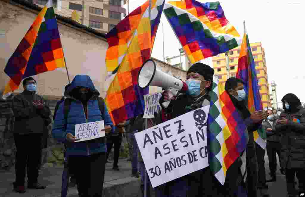 Demonstrators hold "assassin" signs demanding 30 years prison time for Bolivia's former interim President Jeanine Anez outside Miraflores women's prison where she is being held while on trial in La Paz, Bolivia.