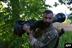 A Ukrainian serviceman holds a just received Next Generation Light Anti-Armour Weapon (NLAW) on the position not far from the Ukrainian town of Chuguiv, in Kharkiv region on June 9, 2022.