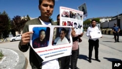 FILE - Uyghur Turks who said they hadn't heard any news about relatives in Eastern Turkistan attend a protest near the Chinese Embassy, in Ankara, Turkey, May 24, 2022. 