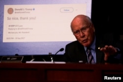 File — U.S. Senator Pat Leahy (D-VT) shows a retweet by then-U.S. President Donald Trump of an alleged Russian troll account, on Capitol Hill in Washington, October 31, 2017.