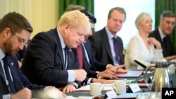 Britain's Prime Minister Boris Johnson, second left, addresses his Cabinet during his weekly Cabinet meeting at Downing Street in London, June 7, 2022.