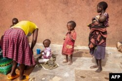 Mothers stay with malnourished children at Kaabong hospital in Kaabong, Karamoja region, Uganda, on May 25, 2022. (AFP/Badru KATUMBA)