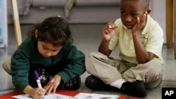 In this photo taken Thursday, Dec. 9, 2010, Young students work on their writing skills in a kindergarten class at Berkeley Maynard Academy in Oakland, Calif. (AP Photo/Marcio Jose Sanchez)