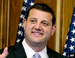 FILE - U.S. Rep. David Valadao, R-Calif., poses during a ceremonial re-enactment of his swearing-in ceremony in the Rayburn Room on Capitol Hill in Washington, Jan. 6, 2015.