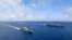 Foto sa a ke Ministe Defans Kore di Sid pibliye montre pot avyon nikleye Ameriken USS Ronald Reagan ak bato Sid Koreyen Marado ki gen yon pot elikopte sou li pandan yon egzesis milite yon kote yo pa presize, Samdi 4 Jyen 2022. 