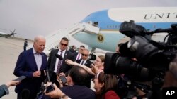 President Joe Biden speaks with reporters before boarding Air Force One at Los Angeles International Airport after attending the Summit of the Americas, Saturday, June 11, 2022, in Los Angeles.