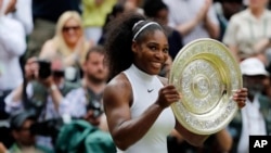 FILE: Serena Williams of the U.S holds her trophy after winning the women's singles final against Angelique Kerber of Germany on day thirteen of the Wimbledon Tennis Championships in London, July 9, 2016.