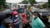 People wait in a long queues to buy fuel for their vehicles at a filling station in Colombo, Sri Lanka, June 11, 2022. 