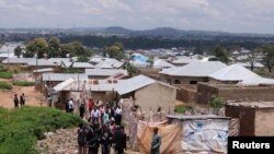 Nigerian authorities escort media through the village of Hayin-Uku near Abuja where they say a two-room bomb-making factory was found September 6, 2011. 