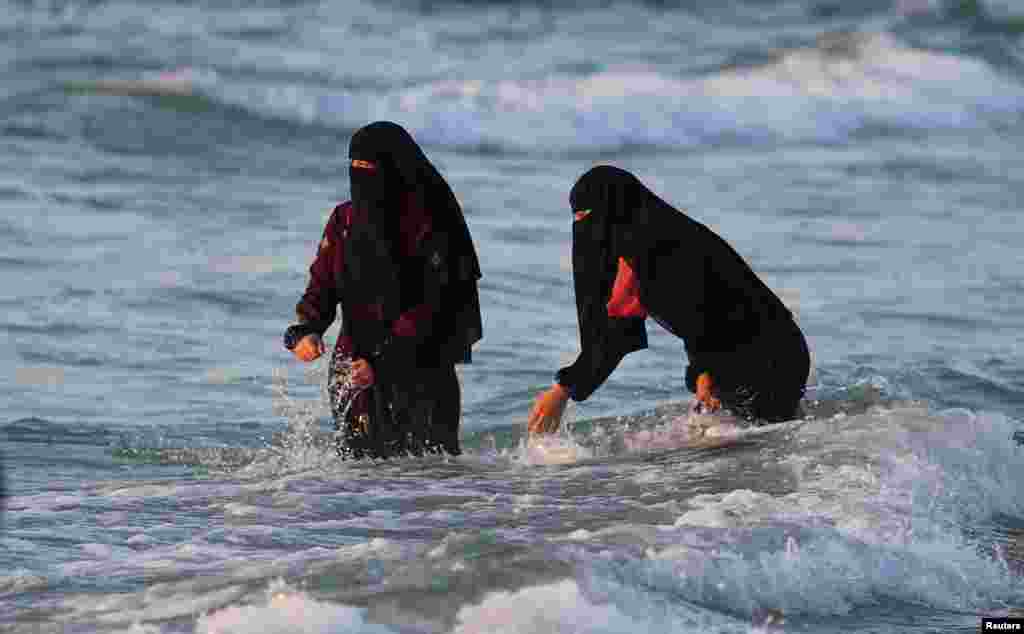 Palestinians enjoy the beach in Gaza City, June 8, 2022. 