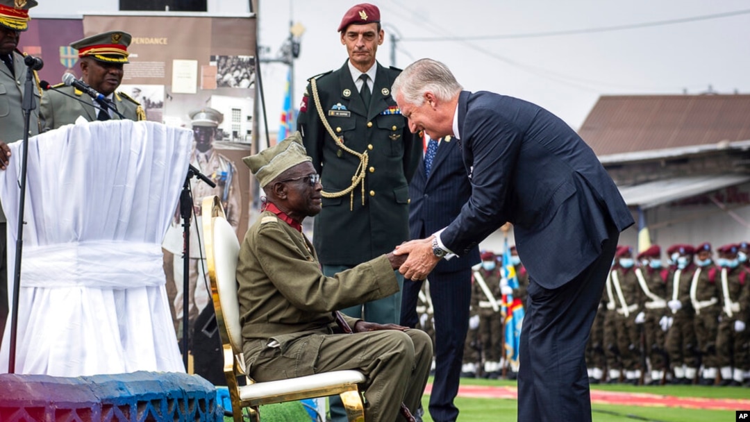 King Philippe of Belgium, right, greets Albert Kunyuku, 100, the last surviving Congolese veteran of World War II, during a ceremony at the Veterans Memorial in Kinshasa, Democratic Republic of the Congo, June 8, 2022. King Philippe was on the second day of a six-day visit.