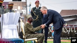 King Philippe of Belgium, right, greets Albert Kunyuku, 100, the last surviving Congolese veteran of World War II, during a ceremony at the Veterans Memorial in Kinshasa, Democratic Republic of the Congo, June 8, 2022. King Philippe was on the second day of a six-day visit.