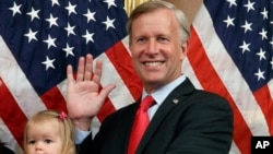 FILE - Congressman Chris Jacobs, R-N.Y., poses for a photo with his daughter Anna, during a ceremonial swearing-in on Capitol Hill, July 21, 2020, in Washington. Jacobs said he will not run for another term in Congress amid backlash over his support for new gun control measures. 