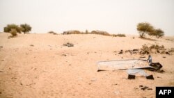 FILE: A picture taken in Timbuktu, on December 8, 2021 shows a rusty sign on the so-called "Jacques Chirac" dune, where the former French President visited the town on 24 October 2003.