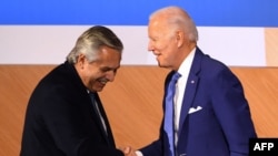 El presidente de Argentina, Alberto Fernández (izquierda), le da la mano al presidente de los Estados Unidos, Joe Biden, después de hablar durante una sesión plenaria de la IX Cumbre de las Américas en Los Ángeles, California, el 9 de junio de 2022.