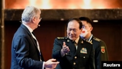 FILE - Then-State Councilor and Defense Minister General of China Wei Fenghe gestures before a plenary session during the 19th Shangri-La Dialogue in Singapore, June 12, 2022.